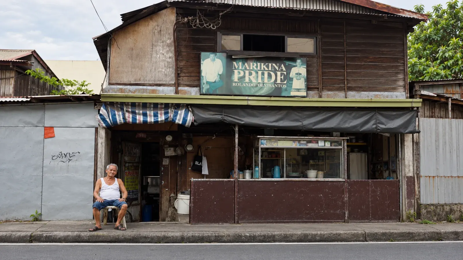 Tatay Oly rests outside his house in Marikina